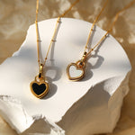 Black and white heart necklace in gold – Modern contrast
