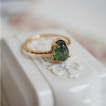 Green teardrop luxury ring in gold – statement design