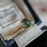 Green teardrop luxury ring in gold – statement design