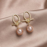 Pearl bow earrings in gold – Feminine touch