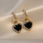 Black heart earrings in gold – Dramatic contrast