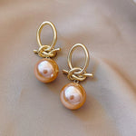 Pearl bow earrings in gold – Feminine touch