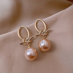 Pearl bow earrings in gold – Feminine touch