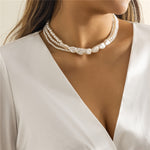 Gold necklace with white stones and pearls – statement design