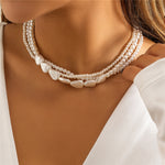 Gold necklace with white stones and pearls – statement design