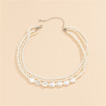 Gold necklace with white stones and pearls – statement design